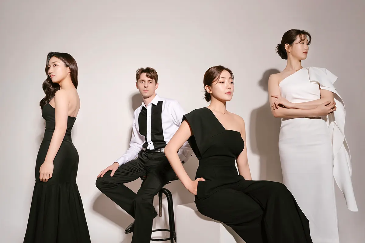 Three young female musicians and one young male musician in formalwear