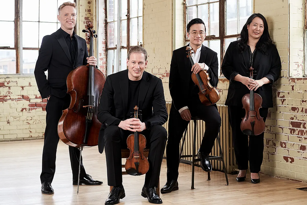 3 male and one female musicians, with 2 violins, a viola and a cello
