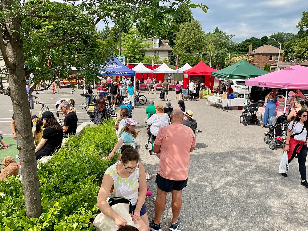 Crowd of people and vendor tents at The Eglinton Way Farmers' Market
