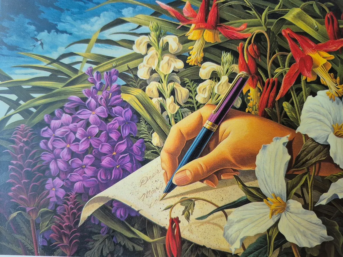 An elegant hand among flowers writing on parchment